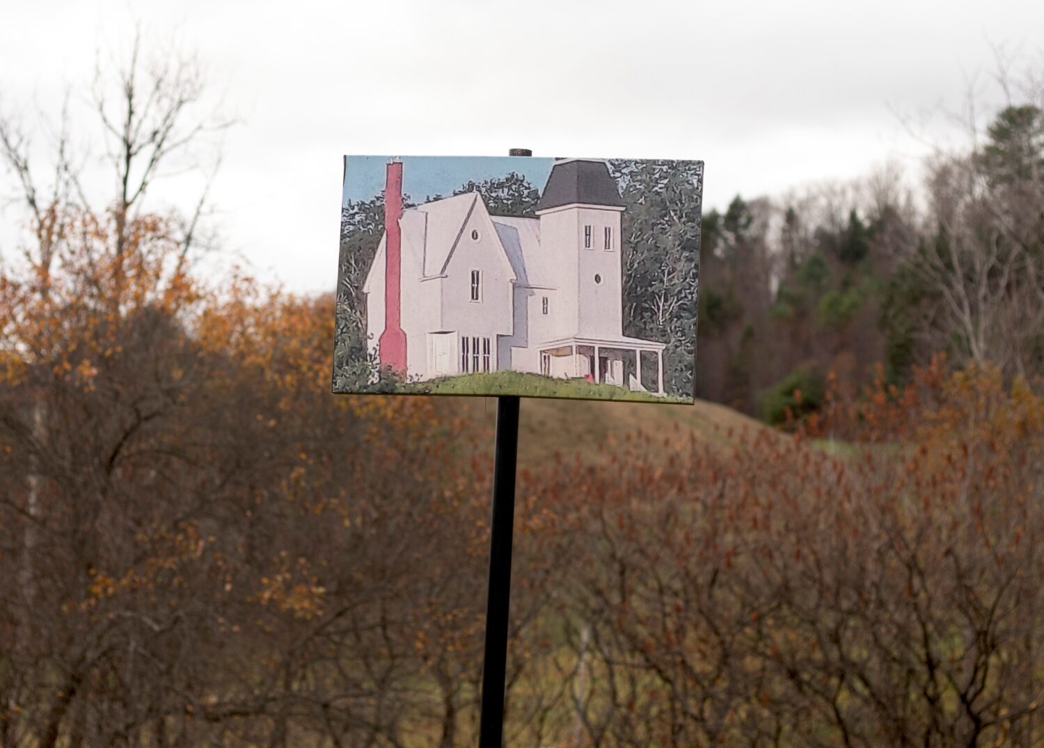 A photo of the home featured in the Beetlejuice films is pictured on a pole in front of the hill wh...