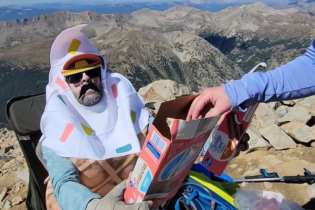 In this photo provided by Blaine Griffin, a man shares ice cream he carried up Huron Peak packed in...