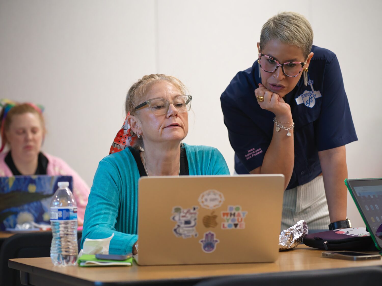 Northside American Federation of Teachers President Melina Espiritu-Azocar, right, speaks with midd...