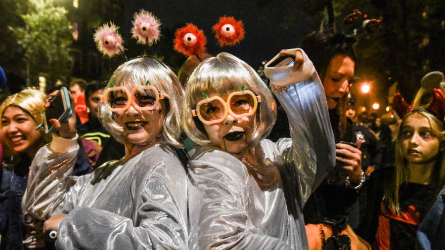 People in costumes participate in an annual Halloween parade. (Photo: Stephanie Keith, Getty Images...