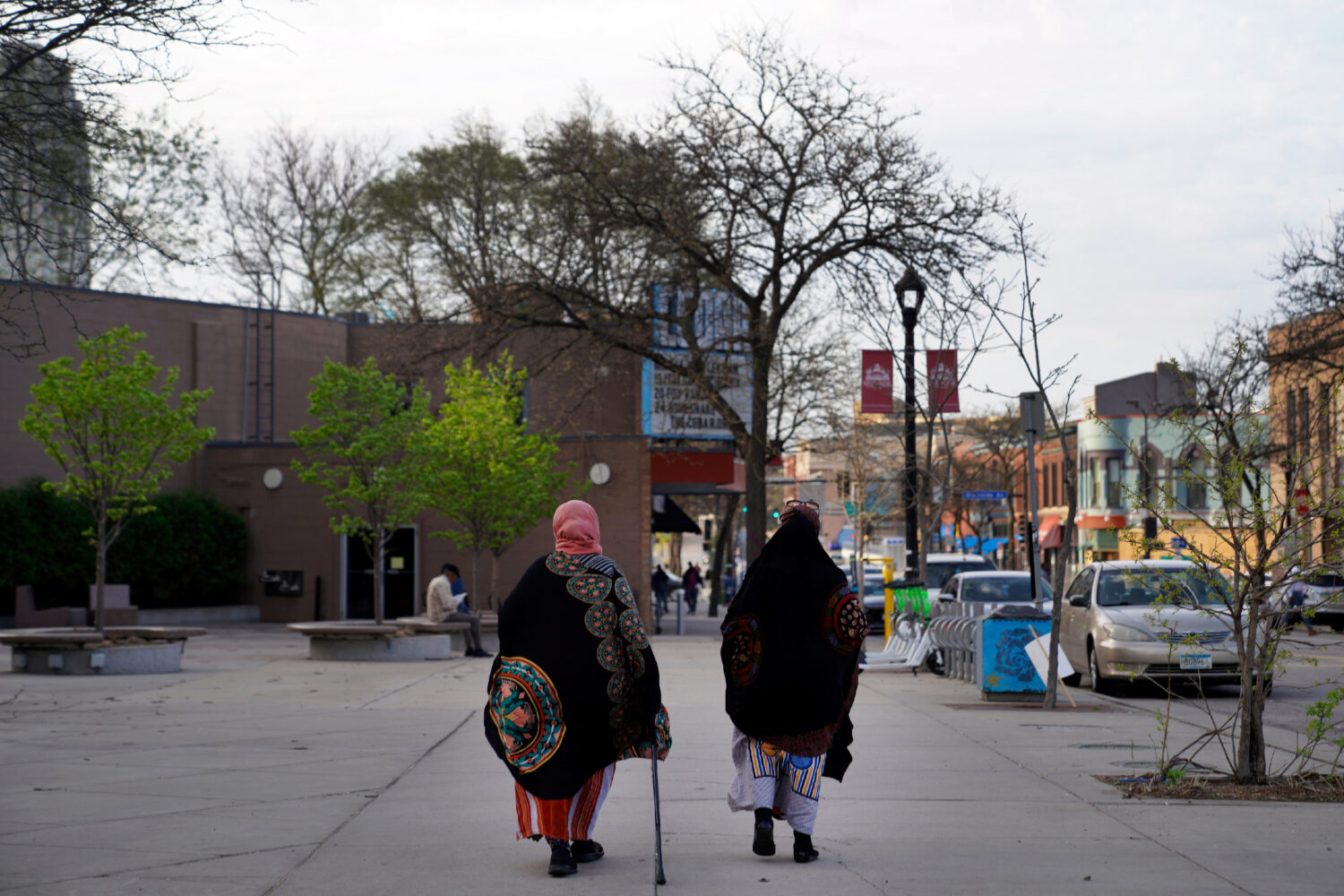 FILE - Women walk down a street in the predominantly Somali neighborhood of Cedar-Riverside in Minn...