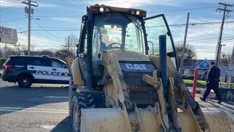 Puyallup police are looking for three masked suspects who used this excavator to rip apart an ATM k...
