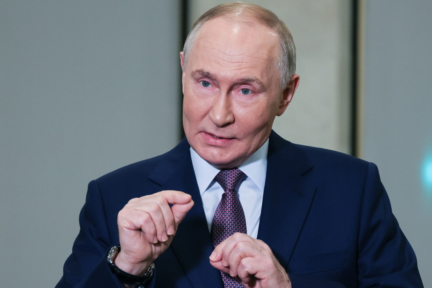 Russian President Vladimir Putin gestures while speaking to journalists on the sidelines of the Rus...
