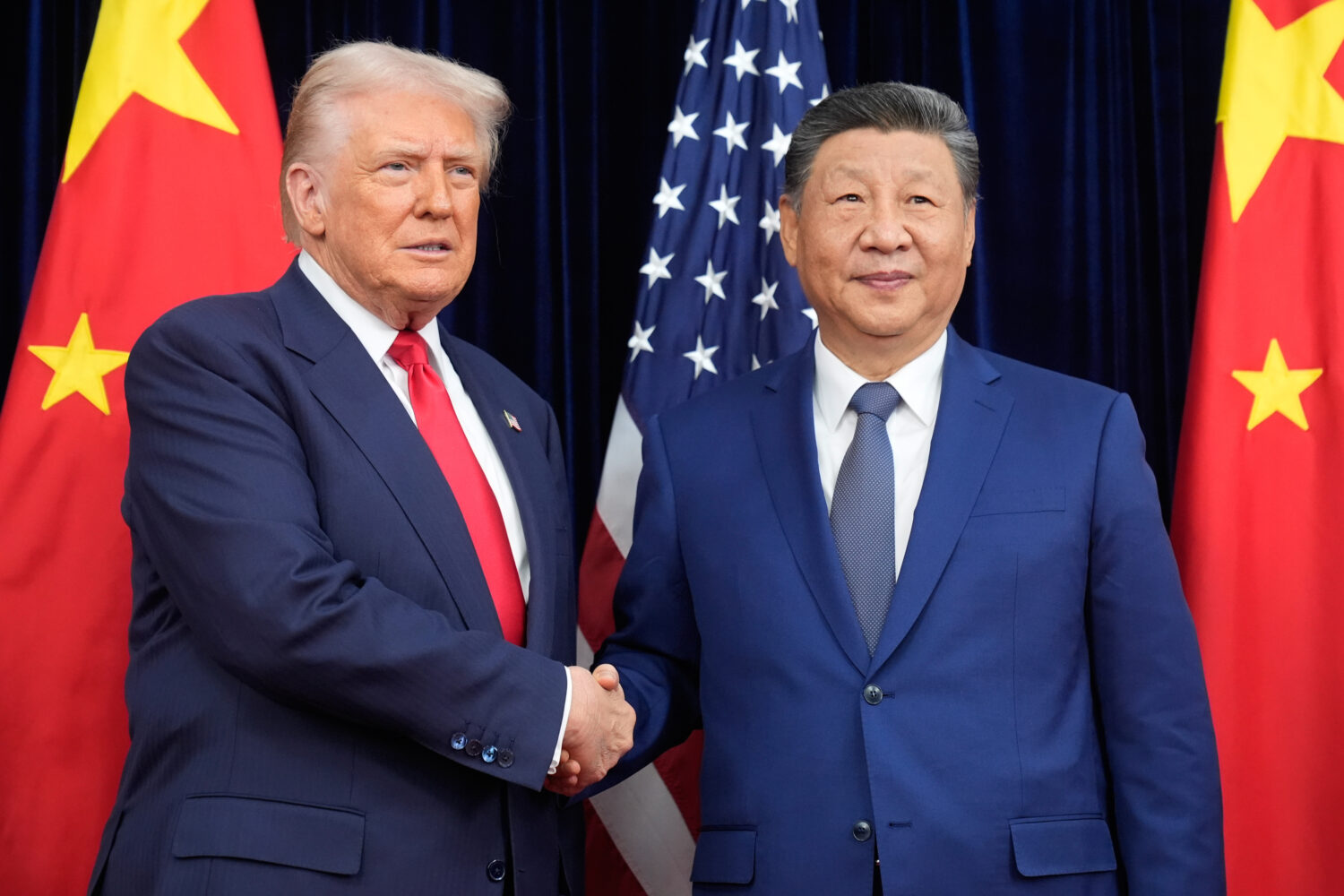 President Donald Trump, left, and Chinese President Xi Jinping shake hands before their meeting at ...