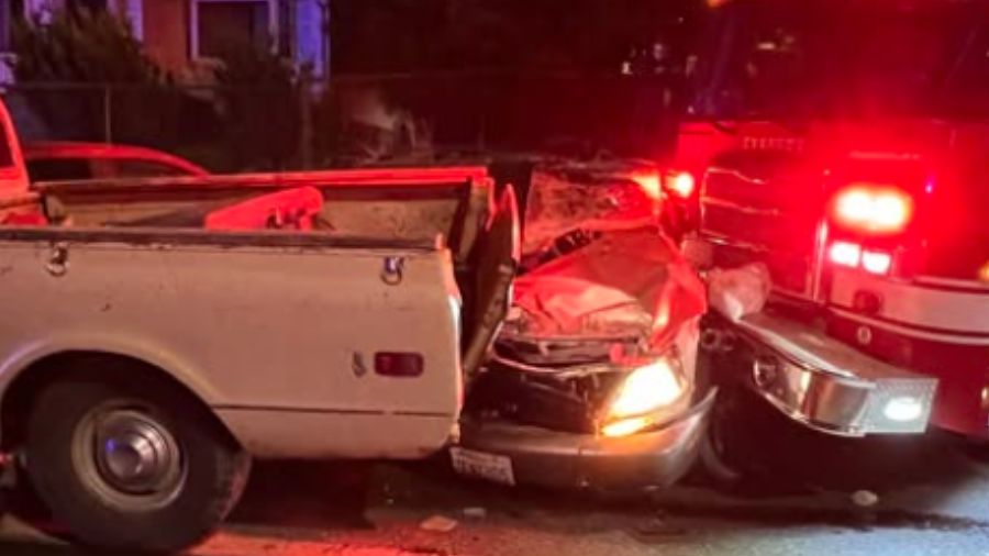 A vehicle ended up wedged between a pickup truck and a fire engine, after a suspect went on a wild joyride in a stolen fire truck in Everett. (Photo: Everett Fire Dept.)