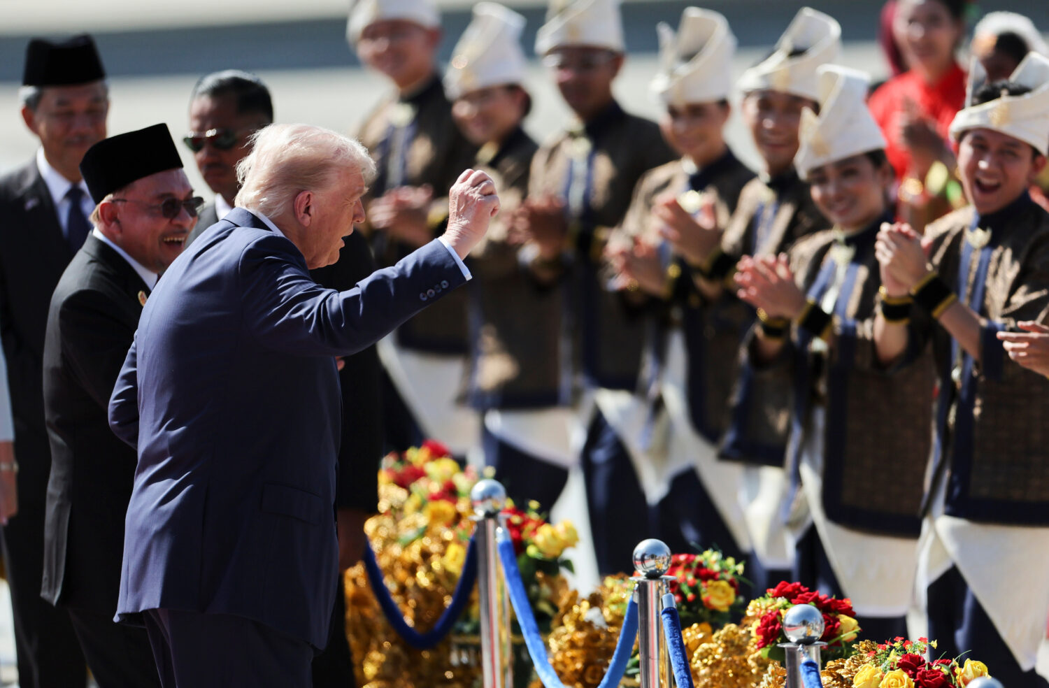 U.S. President Donald Trump reacts to dancing performers during a welcoming ceremony after arriving...