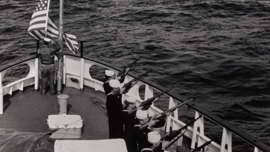Image: A rifle squad aboard the US Coast Guard Cutter SORREL fires a salute to the dead of Flight 2...