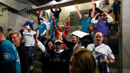 Seattle heats up for Game 5: M's flag raised, local business booms, and rival fans fight over hot dog condiments